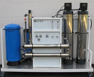 A table with two water filters and one machine.
